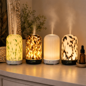 Clare a Beau’s Electric Mist Diffuser collection featuring Green Confetti, Tortoiseshell, Soft White and Dalmatian designs glowing with gentle fragrance mist.